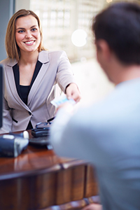 Branch employee smiling at customer-NCR ATM service